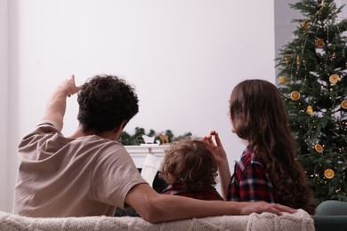Photo of Family watching movie via video projector at home