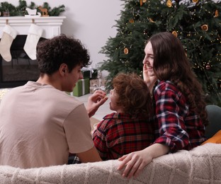 Photo of Family with popcorn spending time together at home. Watching movie via video projector