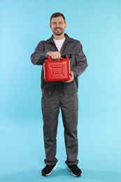 Photo of Man holding plastic canister on light blue background