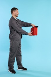 Photo of Man holding plastic canister on light blue background