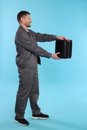 Photo of Man holding plastic canister on light blue background