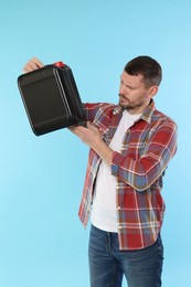Photo of Man holding plastic canister on light blue background