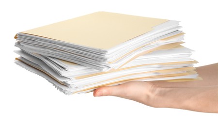 Photo of Woman holding stack of file folders with papers on white background, closeup