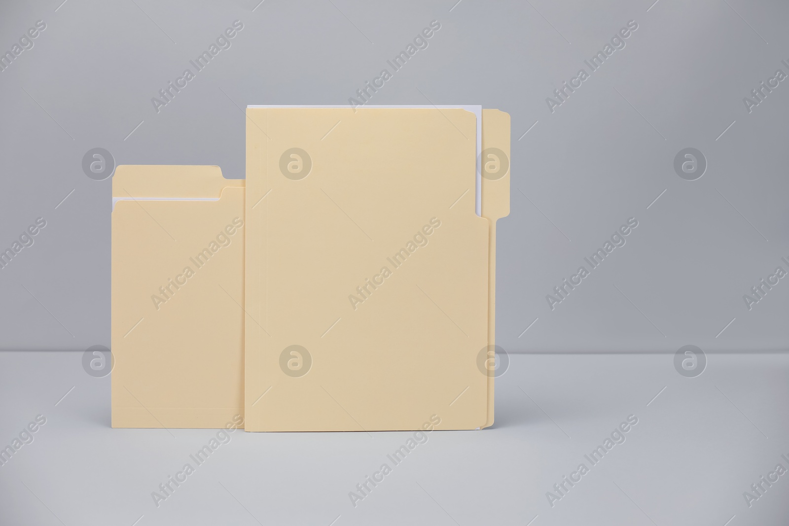 File folders with papers on gray background, space for text Photo of File folders with papers on gray background, space for text