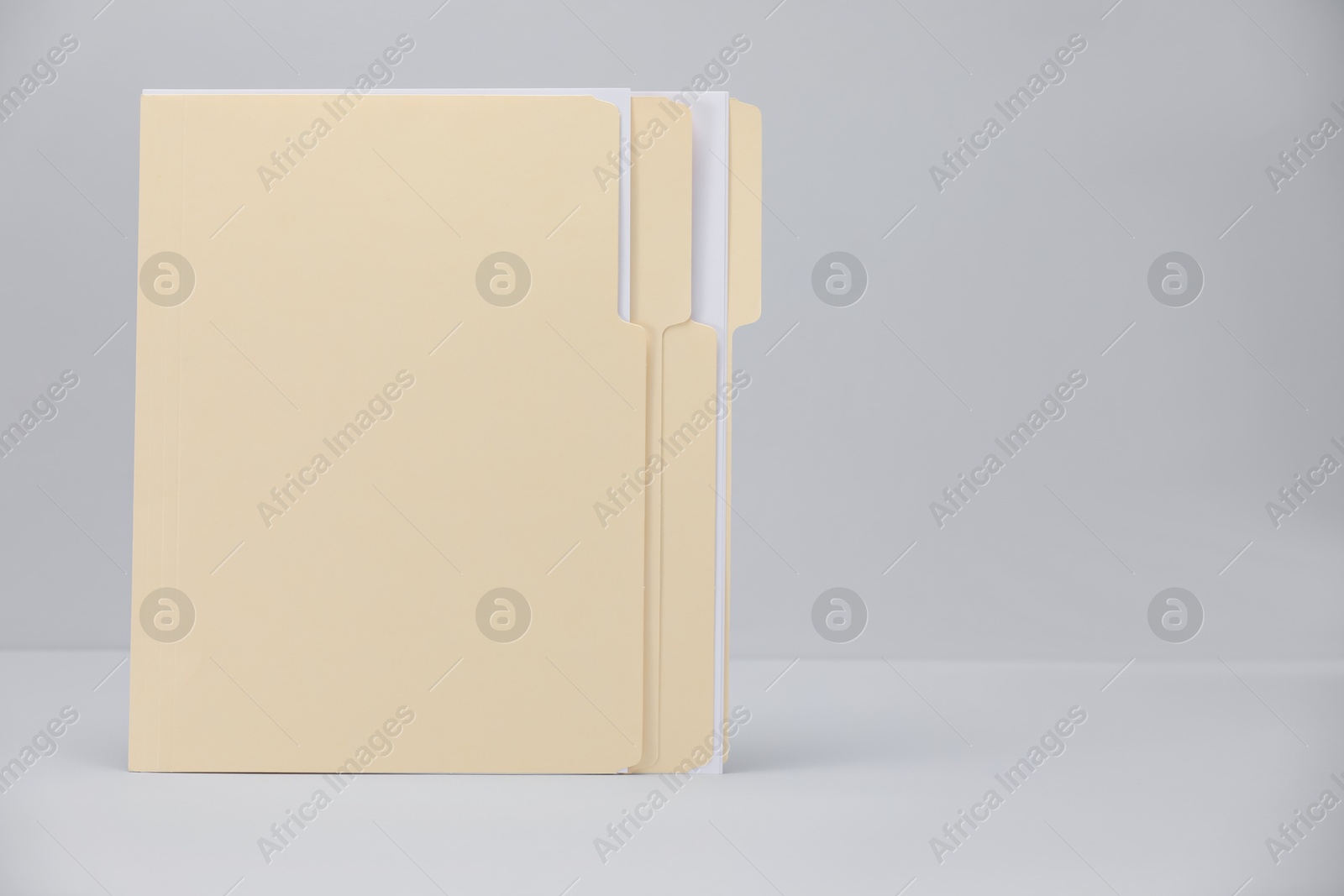 File folders with papers on gray background, space for text Photo of File folders with papers on gray background, space for text