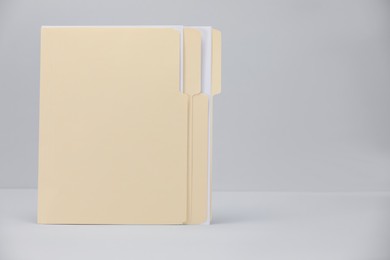 Photo of File folders with papers on gray background, space for text