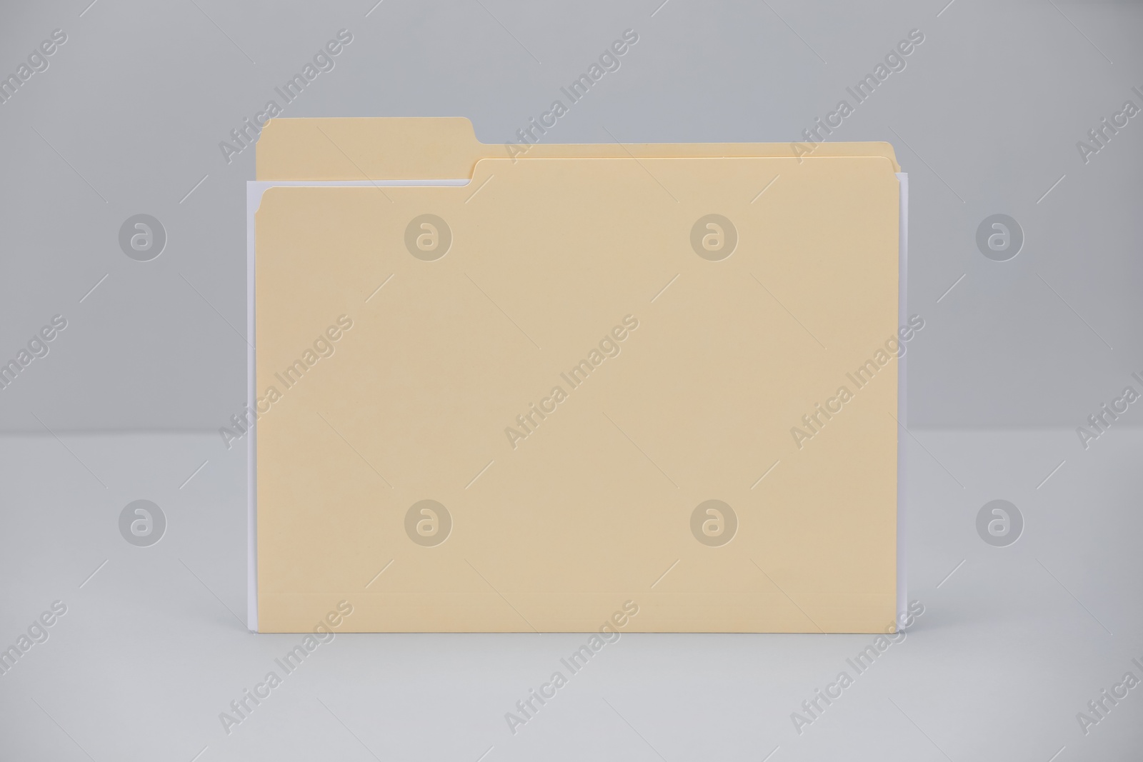 One paper file folder on gray background Photo of One paper file folder on gray background