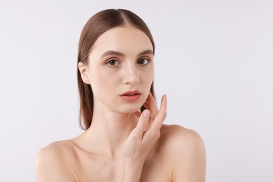 Photo of Portrait of attractive young woman on white background