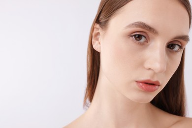 Photo of Portrait of attractive young woman on white background, closeup. Space for text