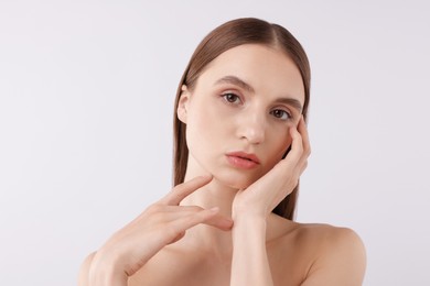 Photo of Portrait of attractive young woman on white background