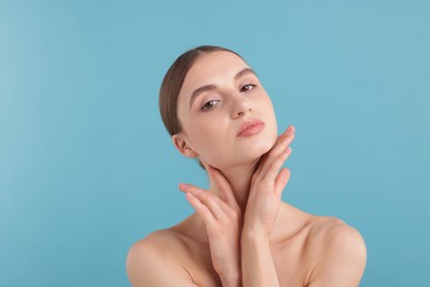 Photo of Portrait of charming young woman on light blue background