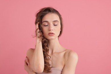 Photo of Portrait of beautiful young woman on pink background