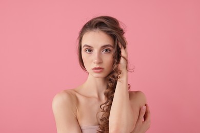 Photo of Portrait of beautiful young woman on pink background