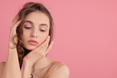 Photo of Portrait of beautiful young woman on pink background. Space for text