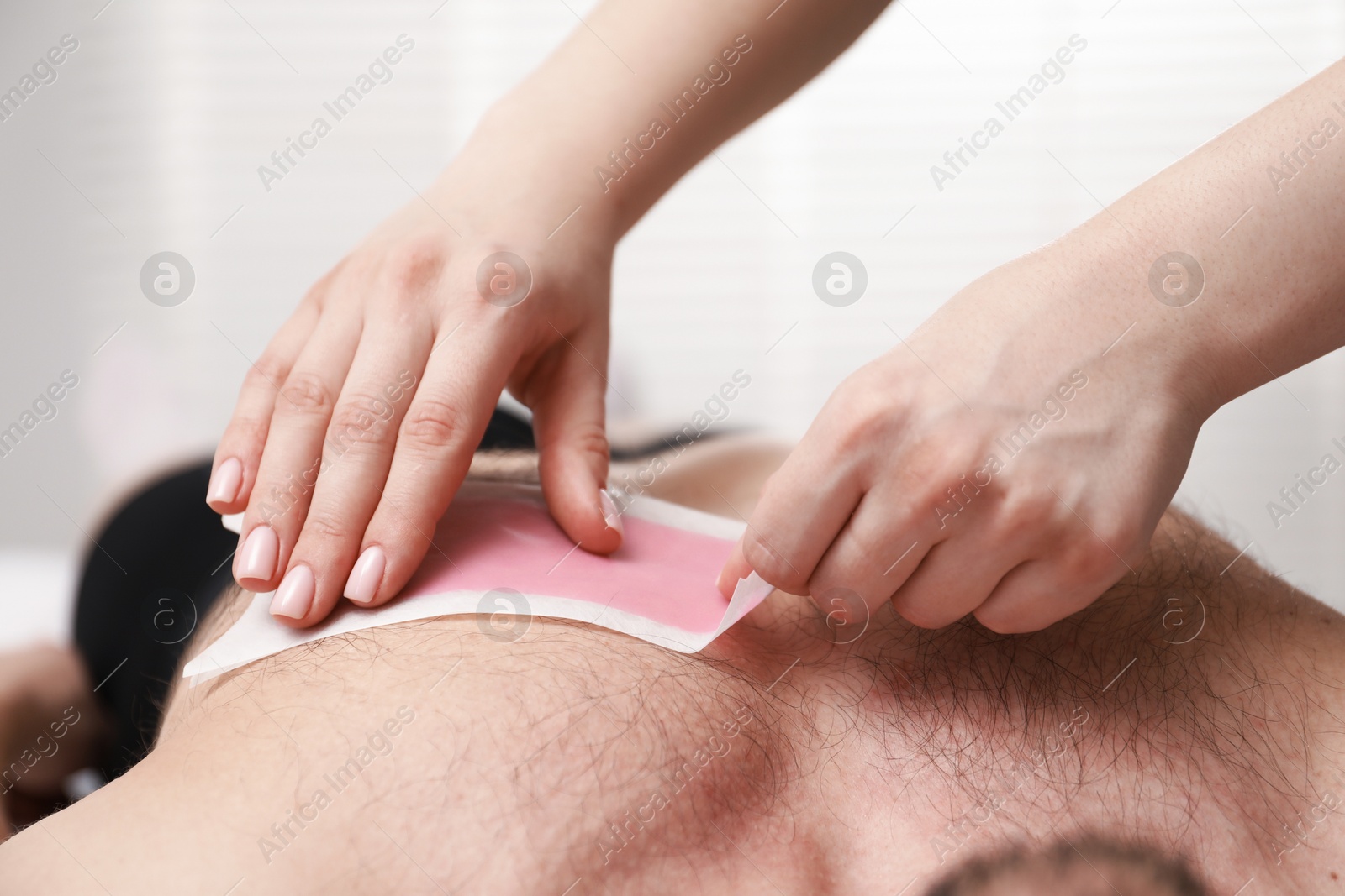 Young man undergoing wax epilation in salon, closeup Photo of Young man undergoing wax epilation in salon, closeup