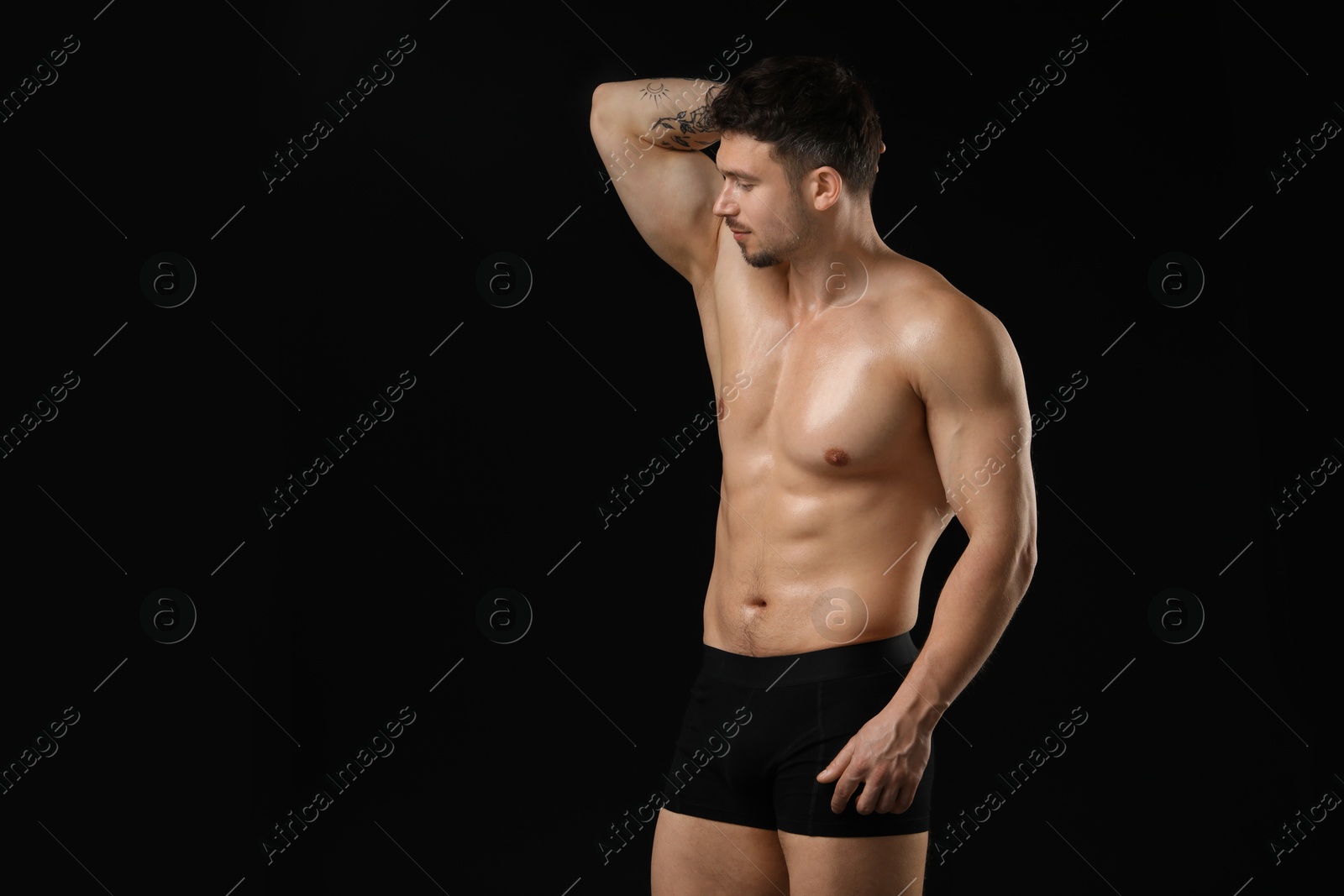 Young man in stylish underwear on black background. Space for text Photo of Young man in stylish underwear on black background. Space for text