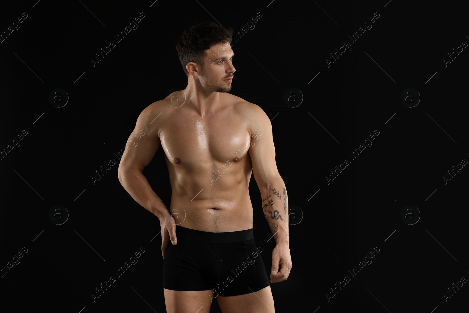 Young man in stylish underwear on black background Photo of Young man in stylish underwear on black background