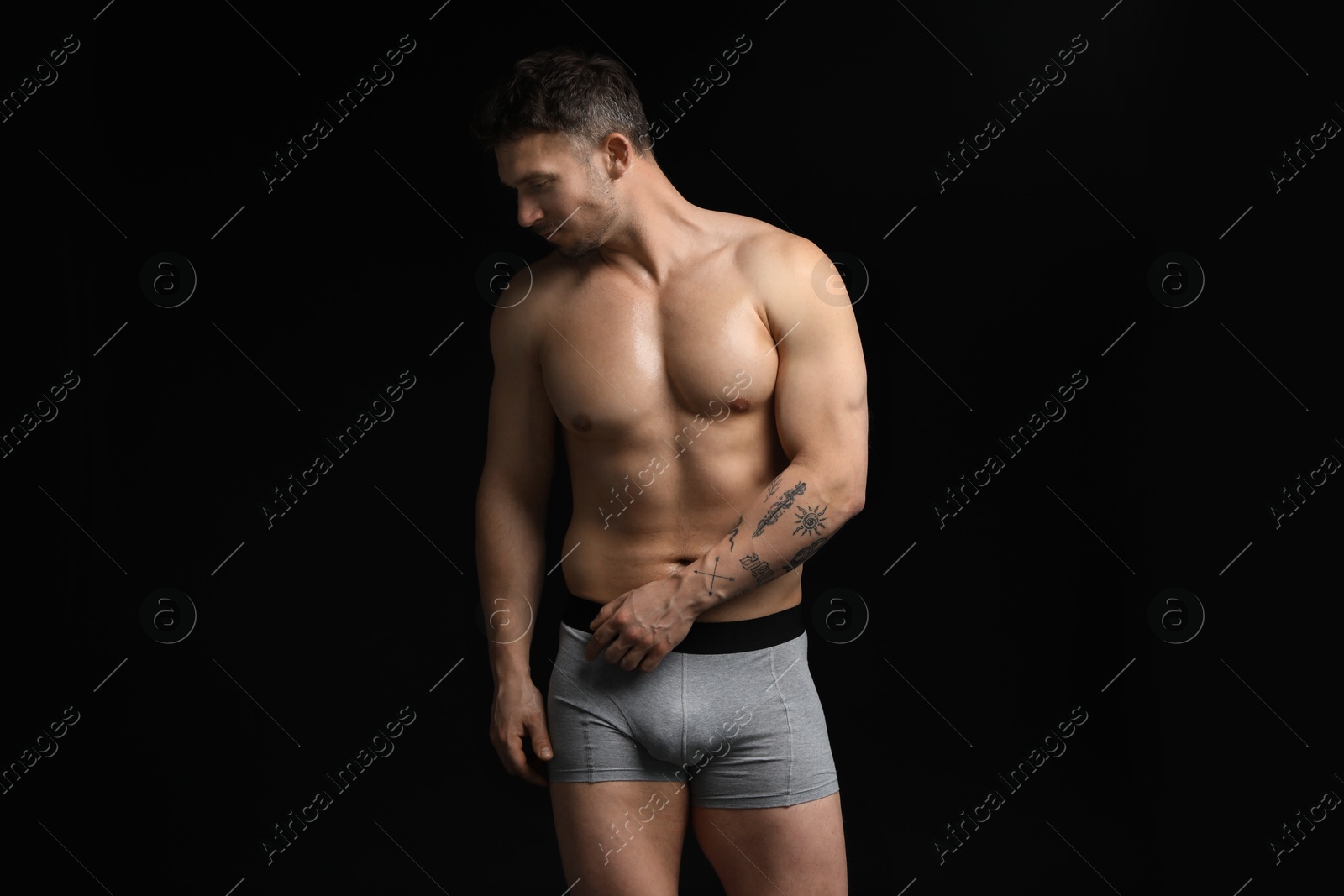 Young man in stylish light grey underwear on black background Photo of Young man in stylish light grey underwear on black background
