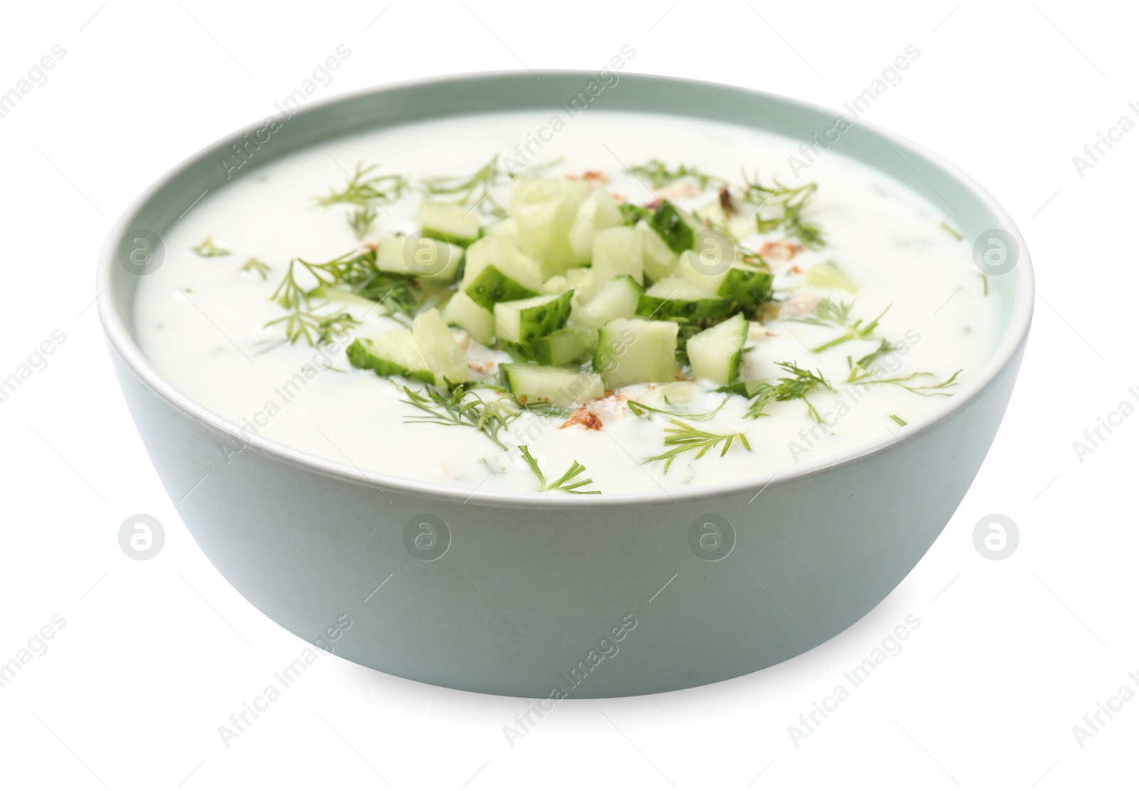 Tasty cucumber soup with dill and nuts in bowl isolated on white Photo of Tasty cucumber soup with dill and nuts in bowl isolated on white