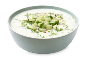 Photo of Tasty cucumber soup with dill and nuts in bowl isolated on white