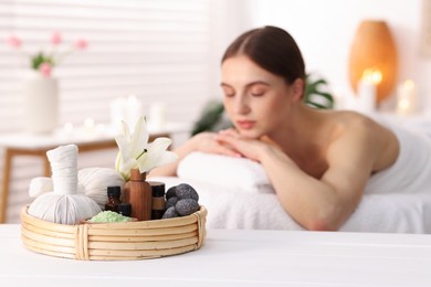 Photo of Beautiful woman relaxing on massage couch in spa salon, selective focus