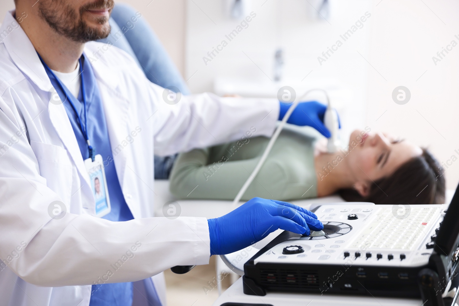 Sonographer conducting ultrasound examination of woman's thyroid gland in clinic, closeup Photo of Sonographer conducting ultrasound examination of woman's thyroid gland in clinic, closeup