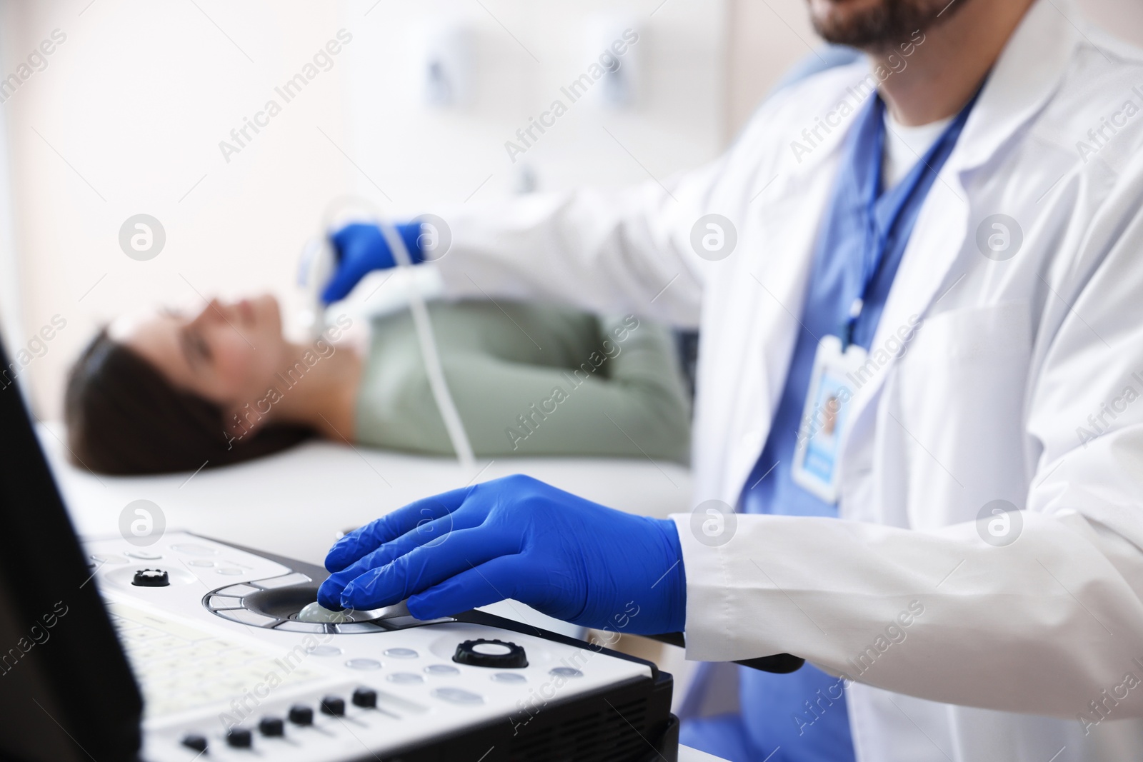 Sonographer conducting ultrasound examination of woman's thyroid gland in clinic, closeup Photo of Sonographer conducting ultrasound examination of woman's thyroid gland in clinic, closeup