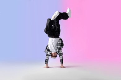 Photo of Boy in stylish clothes dancing on color background