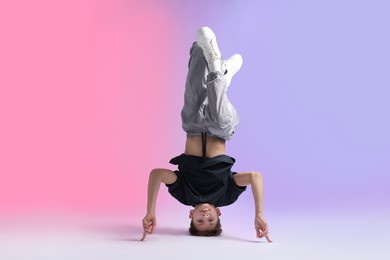 Photo of Boy in stylish clothes dancing on color background
