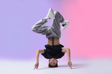 Photo of Boy in stylish clothes dancing on color background