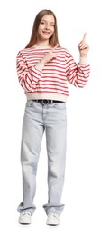 Photo of Teenage girl pointing at something on white background
