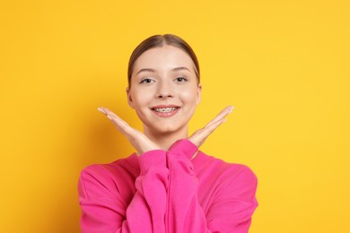 Photo of Portrait of teenage girl on yellow background