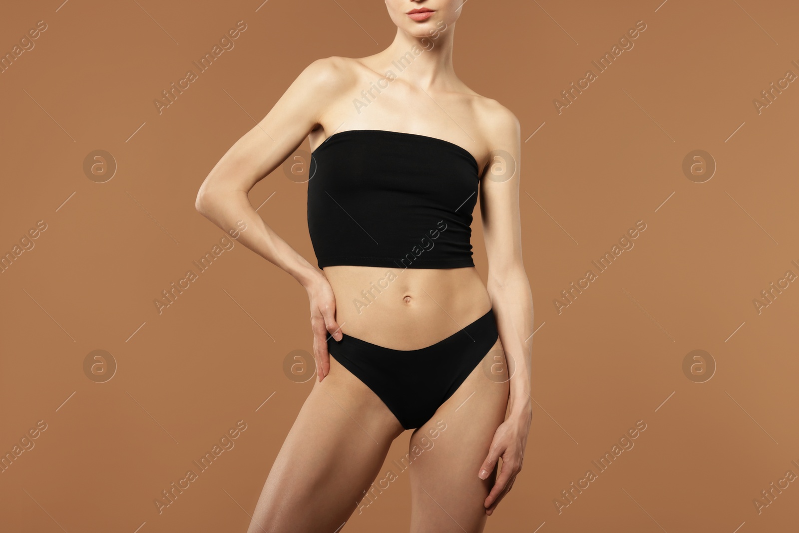 Woman with perfect slim body on beige background, closeup Photo of Woman with perfect slim body on beige background, closeup