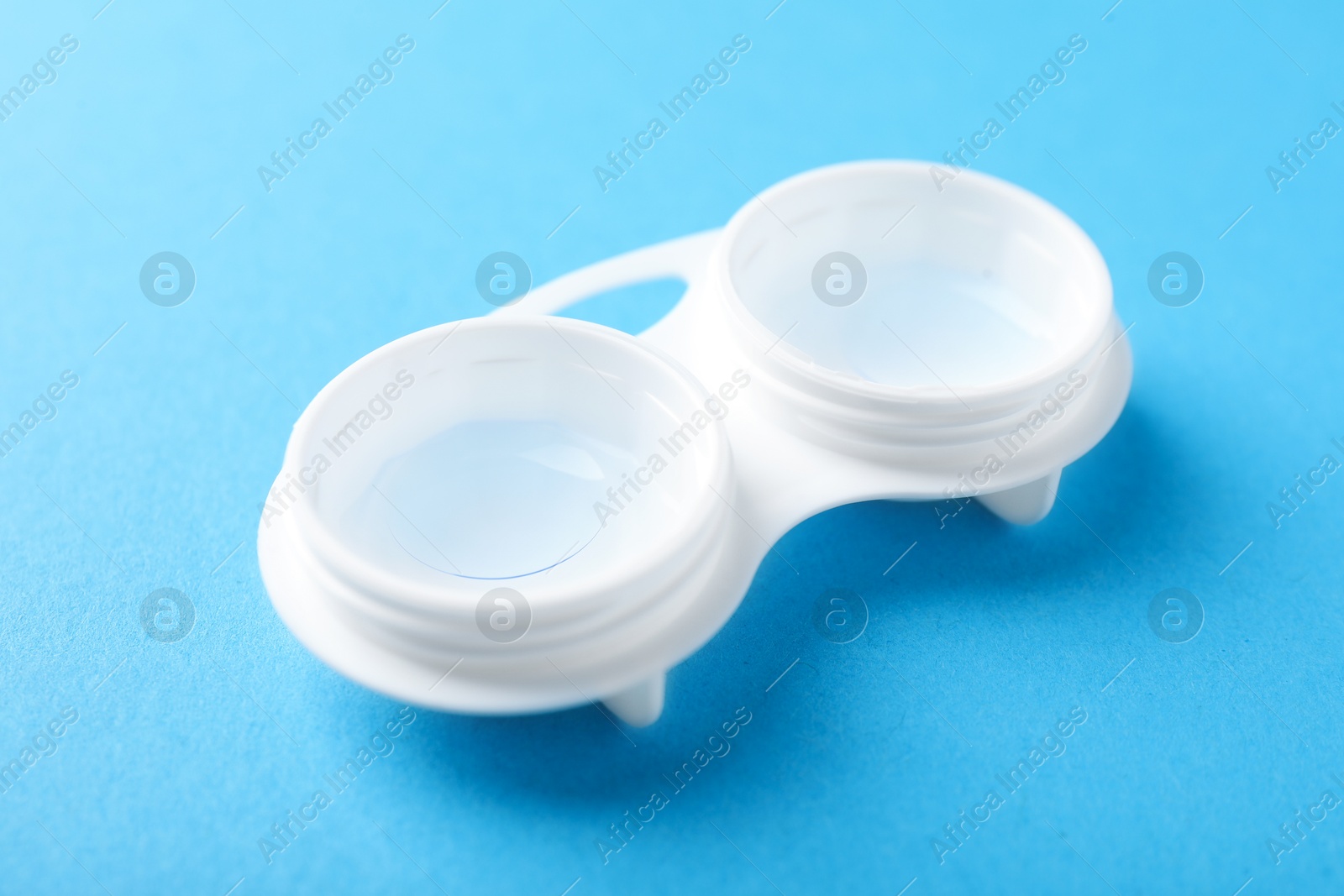 Contact lenses in case on light blue background, closeup Photo of Contact lenses in case on light blue background, closeup