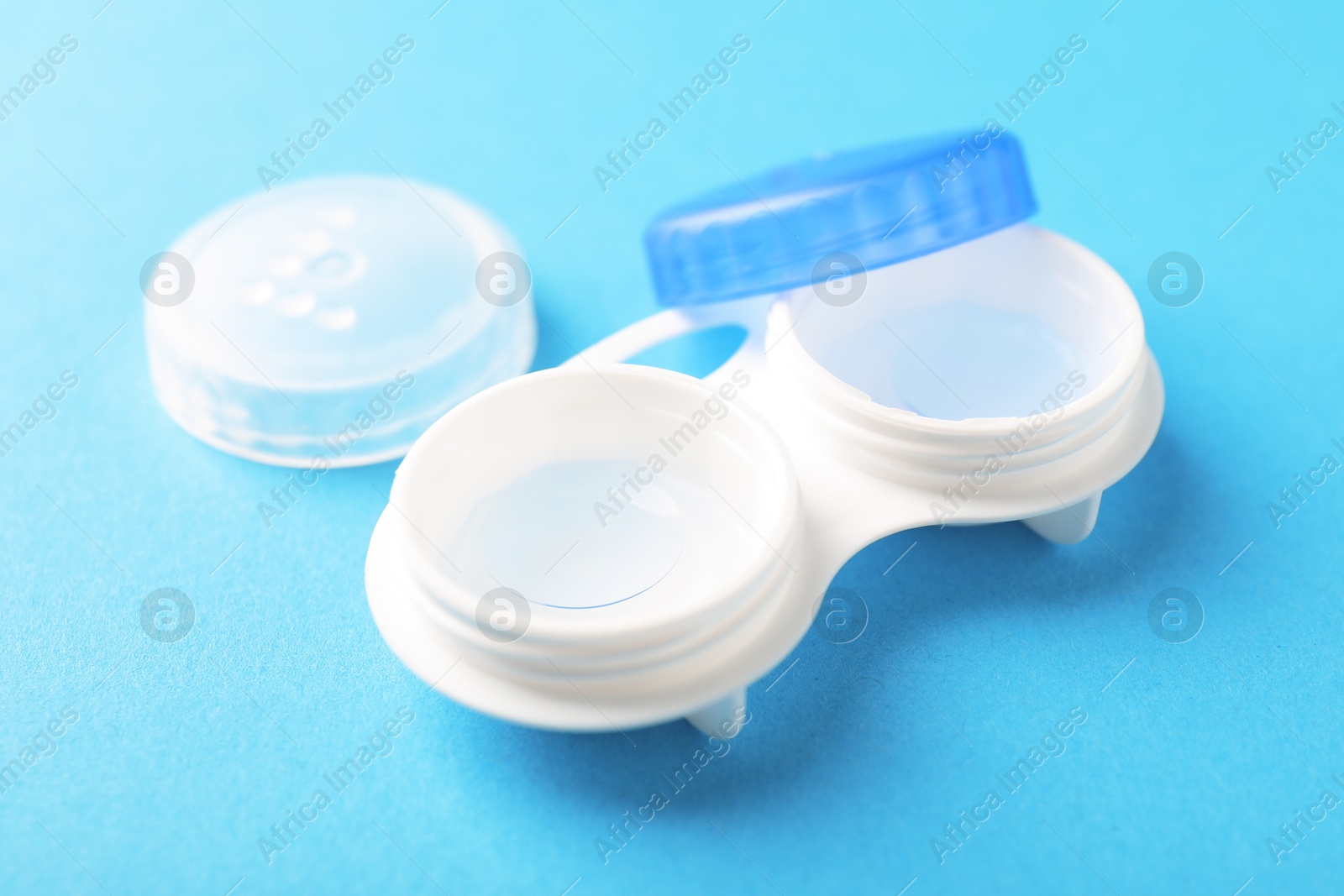 Contact lenses in case on light blue background, closeup Photo of Contact lenses in case on light blue background, closeup