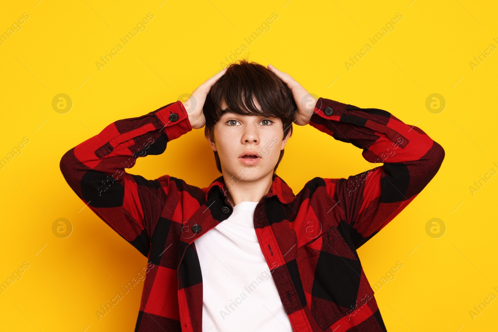 Portrait of teenage boy on orange background Photo of Portrait of teenage boy on orange background
