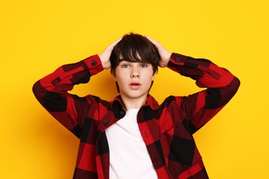 Photo of Portrait of teenage boy on orange background