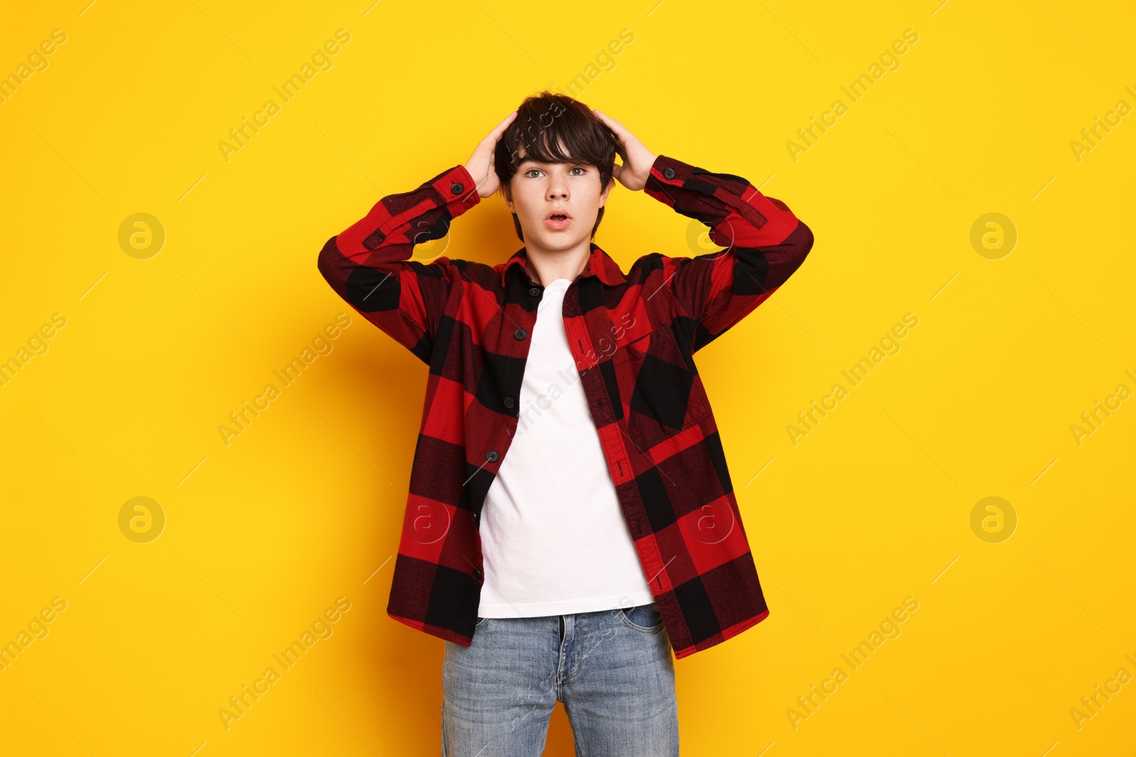 Portrait of teenage boy on orange background Photo of Portrait of teenage boy on orange background