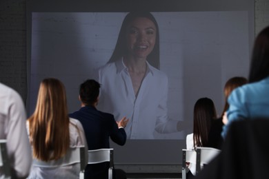Photo of Video conference with female business trainer in office