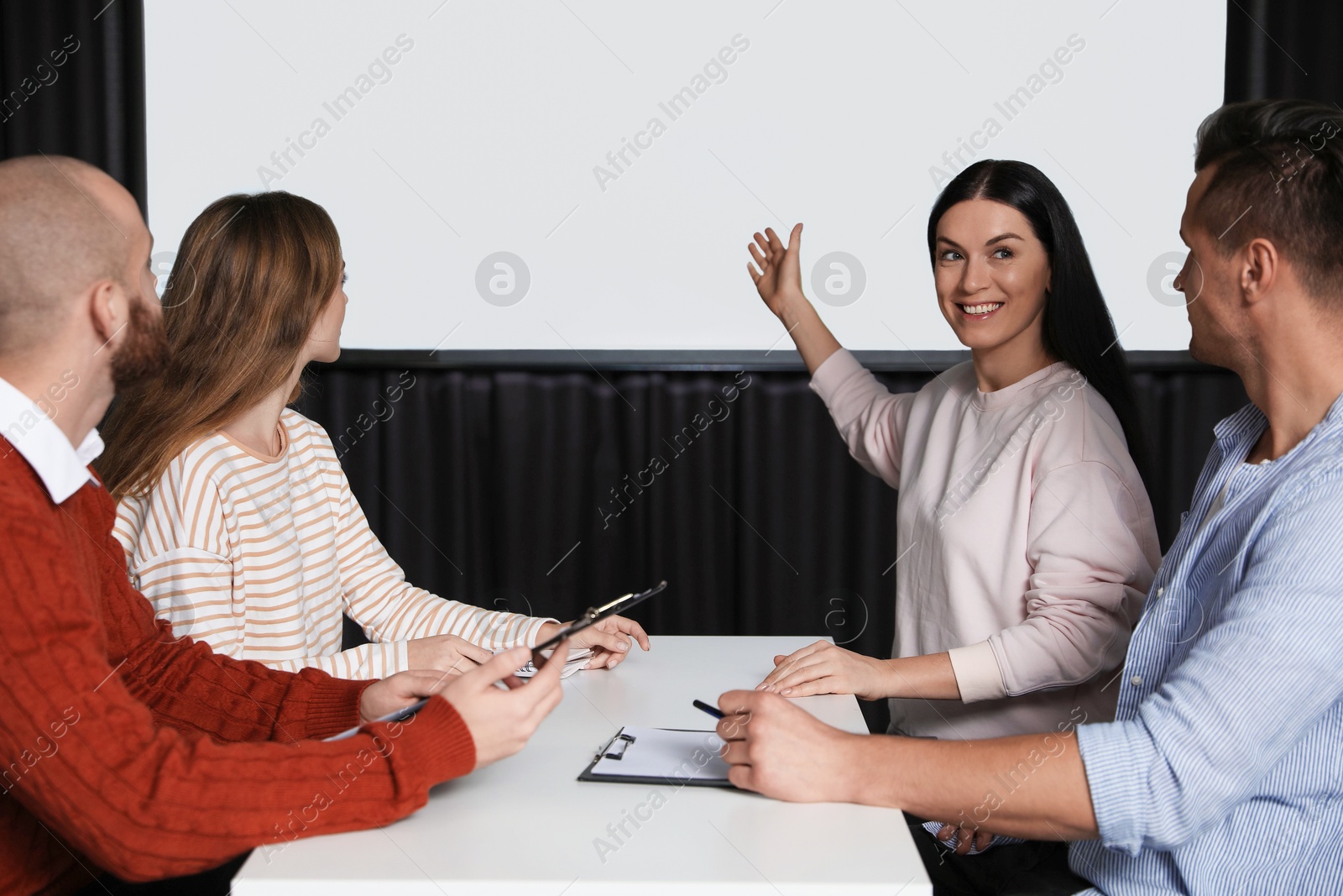 Business people having meeting in conference room with video projection screen Photo of Business people having meeting in conference room with video projection screen