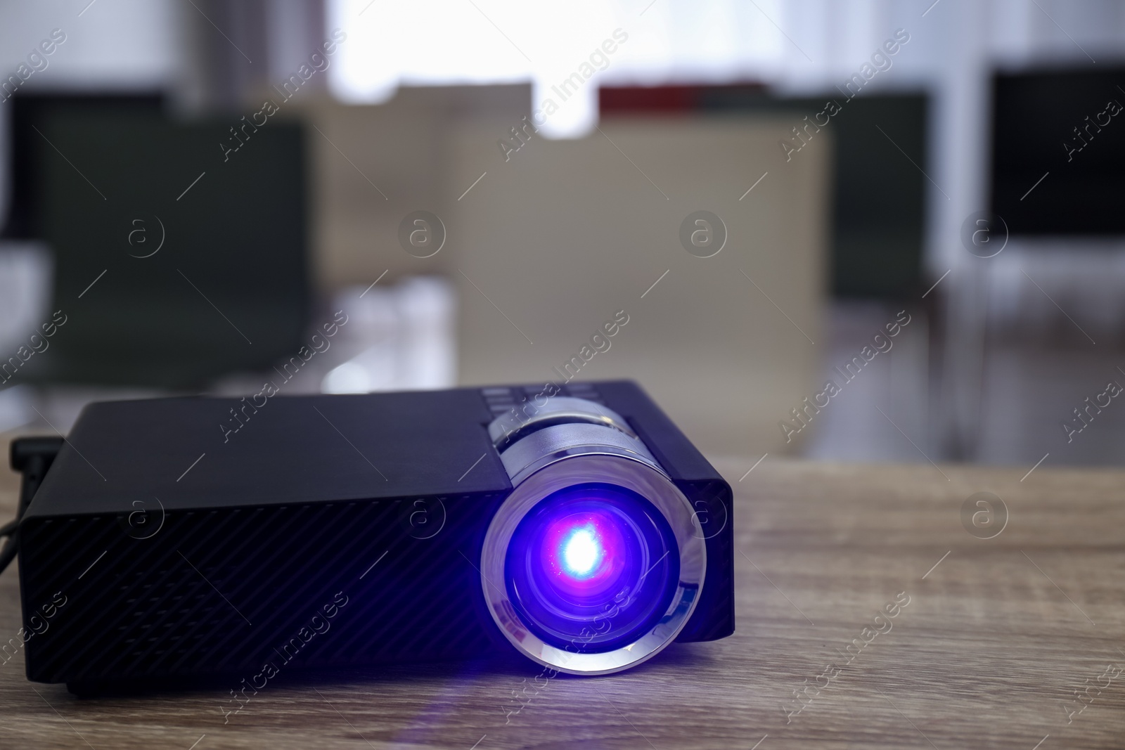 Modern video projector on wooden table in conference room Photo of Modern video projector on wooden table in conference room