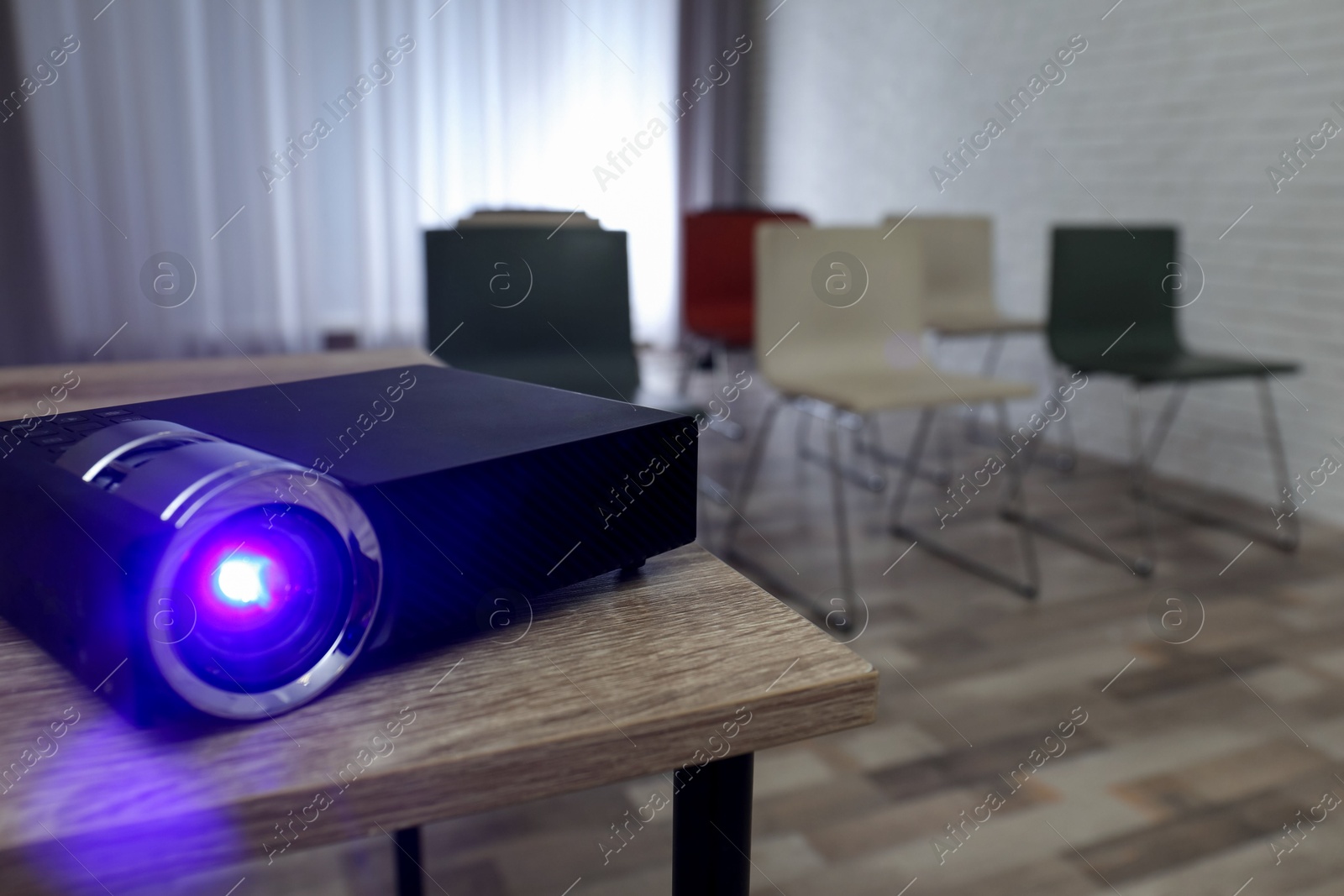 Modern video projector on wooden table in conference room Photo of Modern video projector on wooden table in conference room