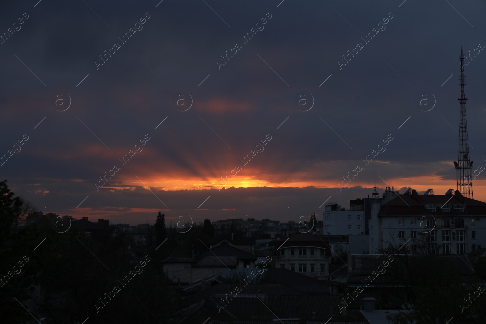 Beautiful view of city under sky lit by sunset Photo of Beautiful view of city under sky lit by sunset