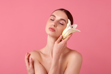 Photo of Portrait of beautiful young woman with flower on pink background. Space for text