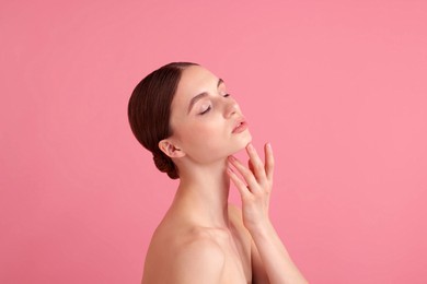 Photo of Portrait of beautiful young woman on pink background. Space for text
