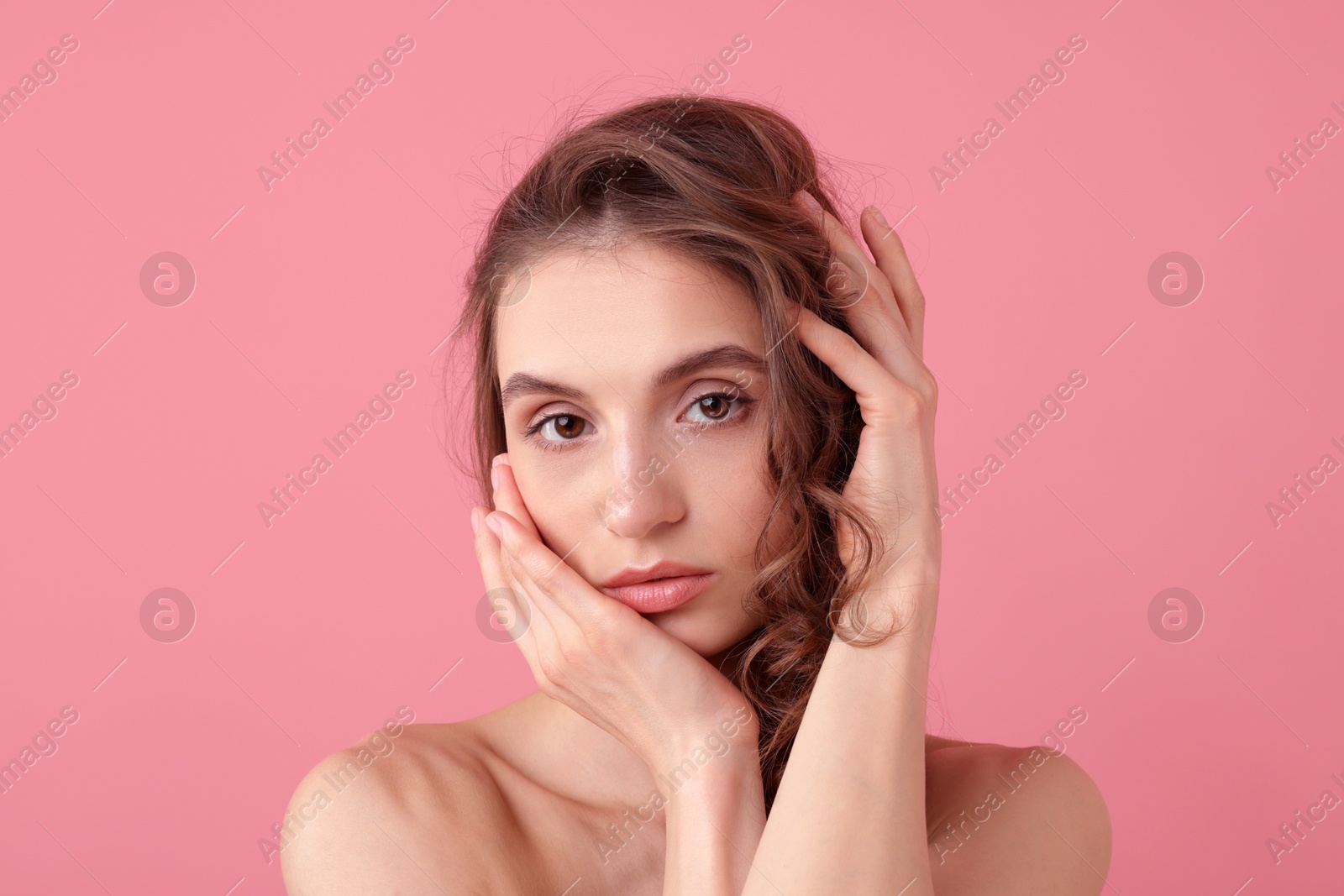 Portrait of beautiful young woman on pink background Photo of Portrait of beautiful young woman on pink background