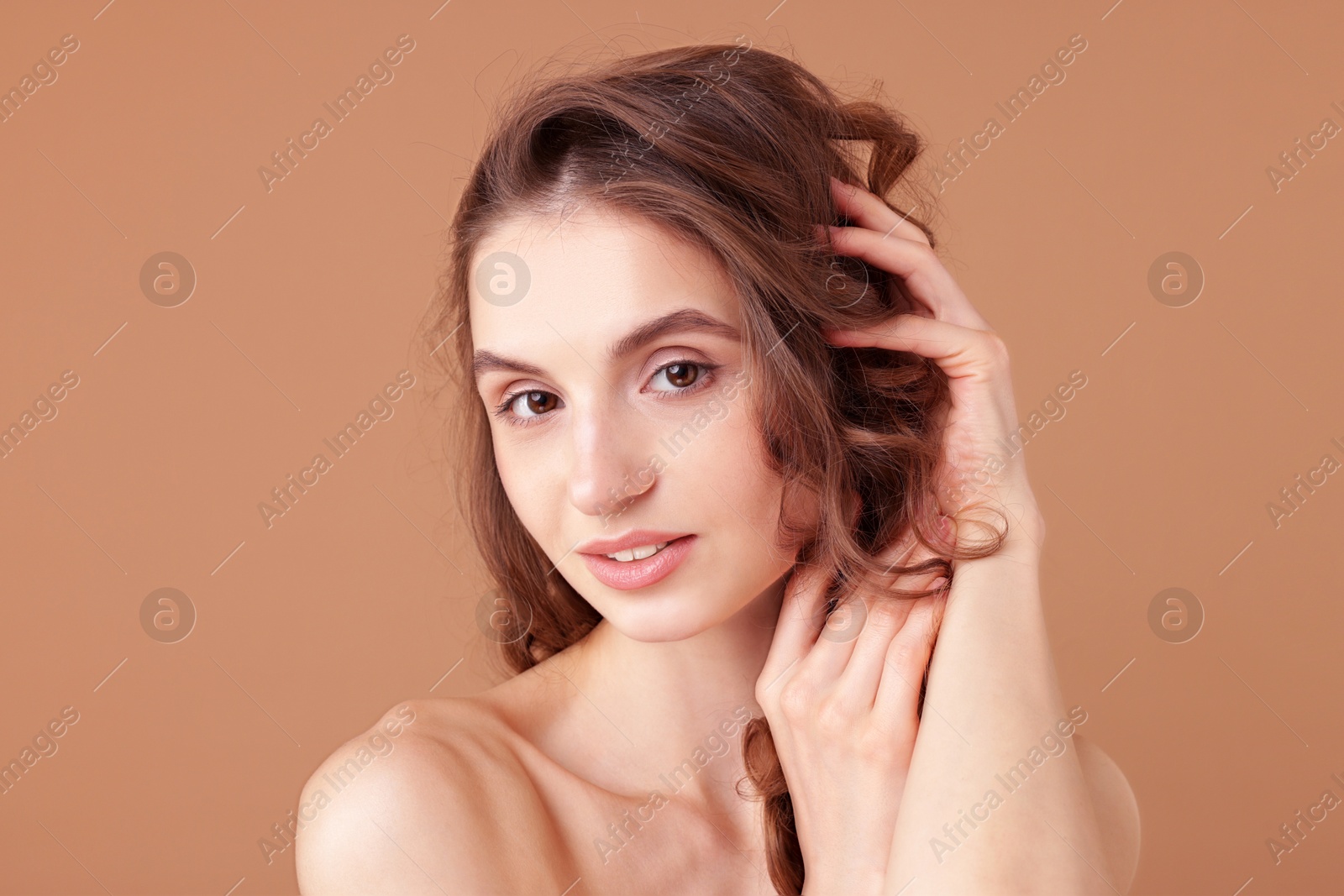 Portrait of beautiful young woman on beige background Photo of Portrait of beautiful young woman on beige background