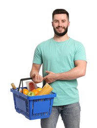 Photo of Man with shopping basket full of products on white background