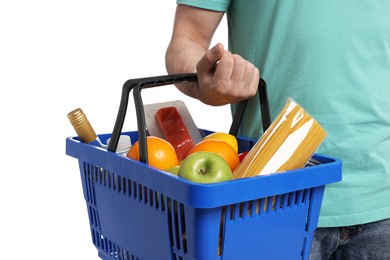 Photo of Man with shopping basket full of products on white background, closeup