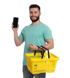 Photo of Man with empty shopping basket and smartphone on white background